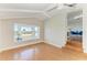 Well-lit bonus room featuring hardwood floors, a bay window with water views and 3-step access to the living room at 2512 Riverside E Dr, Bradenton, FL 34208