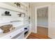 Custom built-in shelving in hallway with views of a bedroom with hardwood floors at 2512 Riverside E Dr, Bradenton, FL 34208