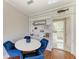 Dining area with hardwood floors, built-in shelving, and stylish blue velvet chairs at 2512 Riverside E Dr, Bradenton, FL 34208