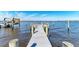 Private wooden dock, boat lift, and waterfront views on a sunny day at 2512 Riverside E Dr, Bradenton, FL 34208