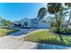 Charming home boasts lush landscaping, a driveway, attached garage, and beautiful lawn at 2512 Riverside E Dr, Bradenton, FL 34208