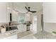 Modern kitchen featuring white cabinets, stainless steel appliances, granite counters and white marble floors at 2512 Riverside E Dr, Bradenton, FL 34208