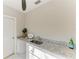 Kitchen featuring granite countertops, white cabinets, and marble floors at 2512 Riverside E Dr, Bradenton, FL 34208