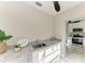 Kitchen featuring granite countertops, white cabinets, and marble floors at 2512 Riverside E Dr, Bradenton, FL 34208