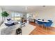 Bright living room featuring hardwood floors, a comfortable couch, and an ocean view from the large windows at 2512 Riverside E Dr, Bradenton, FL 34208