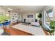 Spacious living room featuring built-in bookshelves, modern furniture, hardwood floors and a water view at 2512 Riverside E Dr, Bradenton, FL 34208