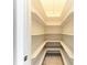 Walk-in pantry with ample shelving and bright lighting at 2512 Riverside E Dr, Bradenton, FL 34208