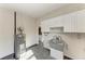 Spacious utility room with a water heater and concrete wash basin at 2512 Riverside E Dr, Bradenton, FL 34208