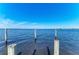 Blue water with a clear blue sky and wooden dock supports at 2512 Riverside E Dr, Bradenton, FL 34208