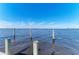 Blue water with a clear blue sky and wooden dock supports at 2512 Riverside E Dr, Bradenton, FL 34208