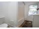 Clean bathroom with a bathtub, shower curtain, and tiled flooring, and window for natural light at 2530 Loma Linda St, Sarasota, FL 34239