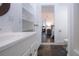 Well-lit bathroom with ample counterspace, shelving and sightlines to a bedroom at 2530 Loma Linda St, Sarasota, FL 34239