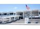 Modern building exterior featuring white columns, concrete stairs, and an American flag at 2530 Loma Linda St, Sarasota, FL 34239