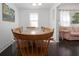 Bright dining room featuring hardwood floors and seating for six, adjacent to the living room at 2530 Loma Linda St, Sarasota, FL 34239