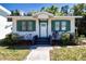 Inviting home exterior showcasing green shutters, a quaint entryway, and tidy landscaping at 2530 Loma Linda St, Sarasota, FL 34239