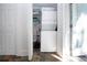 A bright laundry room with a stacked washer and dryer and plenty of storage space at 2530 Loma Linda St, Sarasota, FL 34239