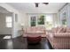 Bright living room featuring striped sofas, dark wood floors, and ample natural light at 2530 Loma Linda St, Sarasota, FL 34239