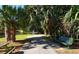 Scenic park view with a paved pathway, bench, picnic table and tranquil pond at 2530 Loma Linda St, Sarasota, FL 34239