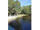 Picturesque pond surrounded by lush greenery and mature trees creating a serene setting at 2530 Loma Linda St, Sarasota, FL 34239