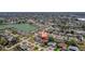 Wide aerial view of neighborhood showing proximity to a nearby lake and neighborhood amenities at 260 Hammock Ter, Venice, FL 34293