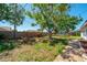 Expansive backyard featuring a firepit, lush trees, and a covered grill area at 260 Hammock Ter, Venice, FL 34293