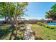 Lush backyard with mature trees, patio, and inviting pool area at 260 Hammock Ter, Venice, FL 34293