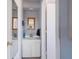 Compact bathroom featuring a vanity with a mirror, white cabinets, and blue walls at 260 Hammock Ter, Venice, FL 34293