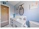 Well-lit blue bathroom features a classic vanity and decor at 260 Hammock Ter, Venice, FL 34293