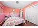 Stylish pink bedroom featuring white trim and a spacious closet at 260 Hammock Ter, Venice, FL 34293