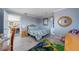 Comfortable bedroom with tile flooring, bright rug, and a side view into dining area at 260 Hammock Ter, Venice, FL 34293