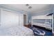 Spacious bedroom with bunk beds, a queen bed, and an anchor-themed rug at 260 Hammock Ter, Venice, FL 34293