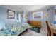 Light-filled bedroom with tile flooring, a vibrant rug, and built in mirror at 260 Hammock Ter, Venice, FL 34293