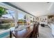Spacious dining room with large windows and a view of the backyard and pool at 260 Hammock Ter, Venice, FL 34293