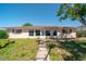 Inviting home exterior with a well-manicured lawn, tiled walkway, and charming front door at 260 Hammock Ter, Venice, FL 34293