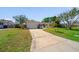 Suburban home featuring a long driveway and well-manicured lawn at 260 Hammock Ter, Venice, FL 34293