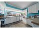 Spacious kitchen with white cabinets, stainless steel appliances, and views to outdoor space at 260 Hammock Ter, Venice, FL 34293