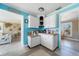 Charming kitchen with blue accent walls and white cabinets at 260 Hammock Ter, Venice, FL 34293