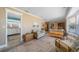 Bright living room with a glimpse into the kitchen, tiled floors, and coastal-inspired decor at 260 Hammock Ter, Venice, FL 34293
