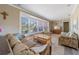 Cozy living room with bay window, comfortable seating, and neutral wall colors at 260 Hammock Ter, Venice, FL 34293