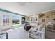Bright living room features tile floors, large windows, and backyard views at 260 Hammock Ter, Venice, FL 34293