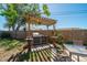 Backyard grilling station with a covered pergola and outdoor seating at 260 Hammock Ter, Venice, FL 34293