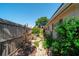 Charming side yard with a brick pathway, mature landscaping, and a cozy seating area at 260 Hammock Ter, Venice, FL 34293