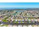 Expansive aerial view showcasing a waterfront neighborhood with numerous homes, canals, and ocean views at 347 Ardenwood Dr, Englewood, FL 34223