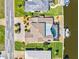 Aerial view of property featuring tile roof, screened lanai, canal access, and boat lift at 347 Ardenwood Dr, Englewood, FL 34223