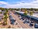 Aerial view of a charming business district with local shops, colorful awnings, and a bustling street filled with cars and pedestrians at 347 Ardenwood Dr, Englewood, FL 34223