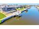 Aerial view of a backyard with a private boat dock and lift situated on a tranquil canal at 347 Ardenwood Dr, Englewood, FL 34223