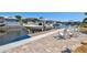 Waterfront backyard with a dock, boat lift, and lounge chairs providing an ideal setting for relaxation and entertainment at 347 Ardenwood Dr, Englewood, FL 34223