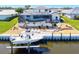 Beautiful waterfront backyard featuring a screened-in pool, dock, and boat lift, perfect for outdoor living at 347 Ardenwood Dr, Englewood, FL 34223