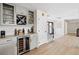 Chic bar area with custom cabinetry, wine storage, and beverage refrigerator, perfect for entertaining at 347 Ardenwood Dr, Englewood, FL 34223