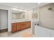Bright bathroom boasts a double sink vanity, granite countertops, and tiled walk-in shower at 347 Ardenwood Dr, Englewood, FL 34223